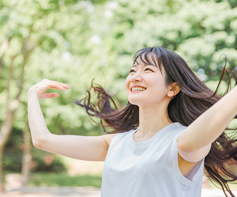 髪を靡かせている笑顔の女性